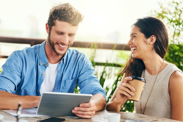 Online is the best place to source inspiration Shot of two businesspeople using a digital tablet together outdoors