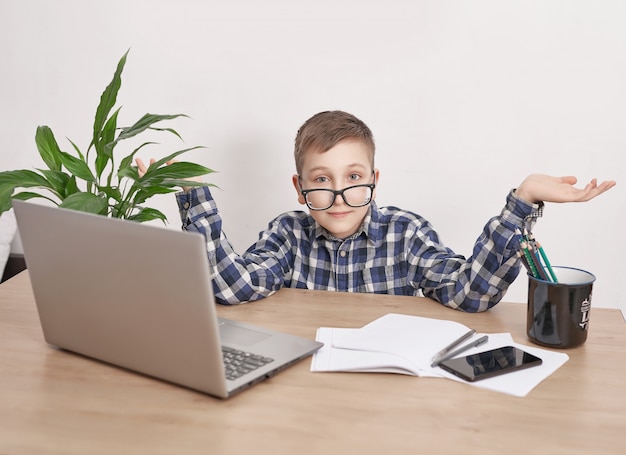 Online lesson at home, social distance during quarantine, self-isolation, online education concept, home schooler. Boy learning language online, using laptop, distance education. Student boy, school