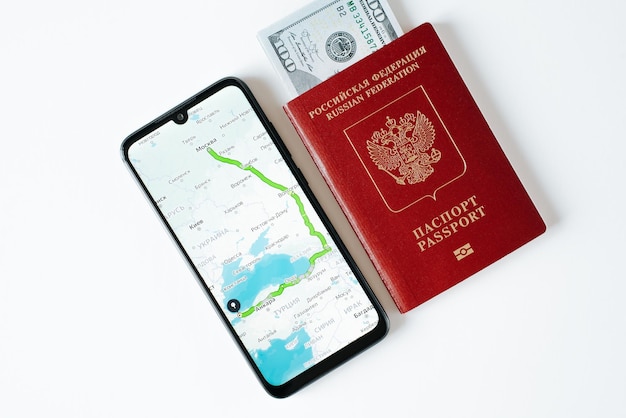 Online map app with geolocation and travel route on mobile phone Russian international passport and money Trip journey emigration vacation concept Closeup top view
