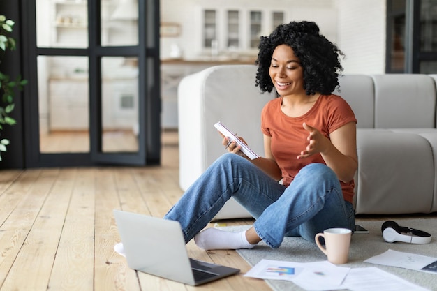 Online meeting smiling black woman making video call with laptop at home