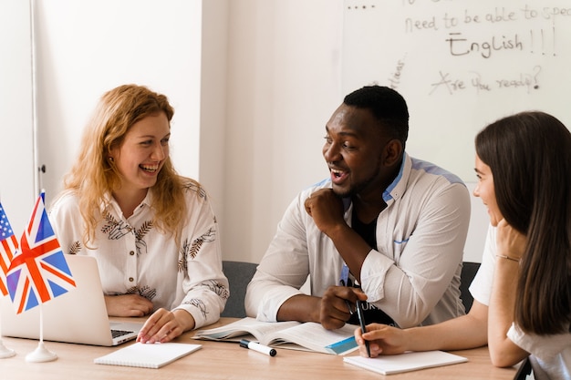 Photo online multiethnic attractive group of teachers study and laught, discuss something