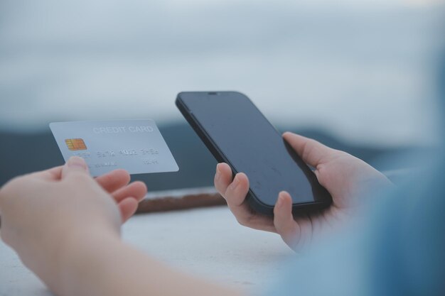 online payment young woman holding credit card and typing on laptop