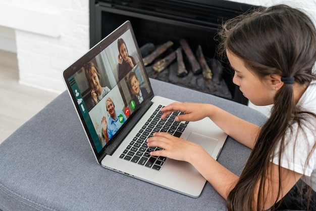 Online remote learning. School kids with computer having video conference chat with teacher and class group. Child studying from home. Homeschooling during quarantine and coronavirus outbreak.