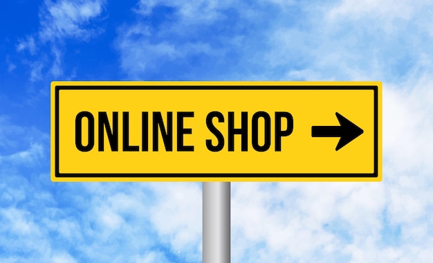 Online shop road sign on sky background