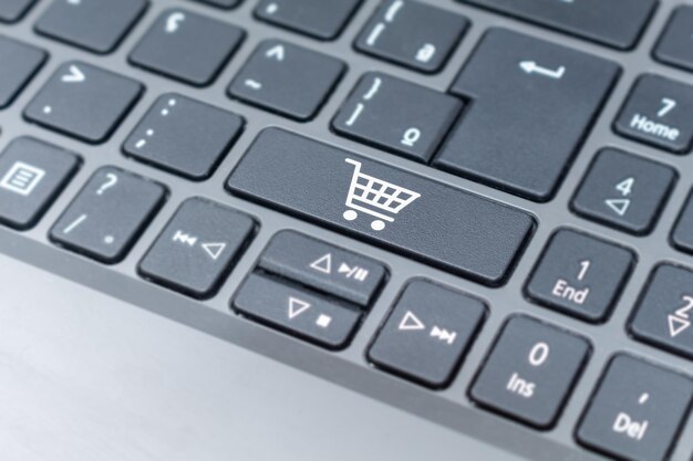 Online shopping cart icon on keyboard key ecommerce\
concept