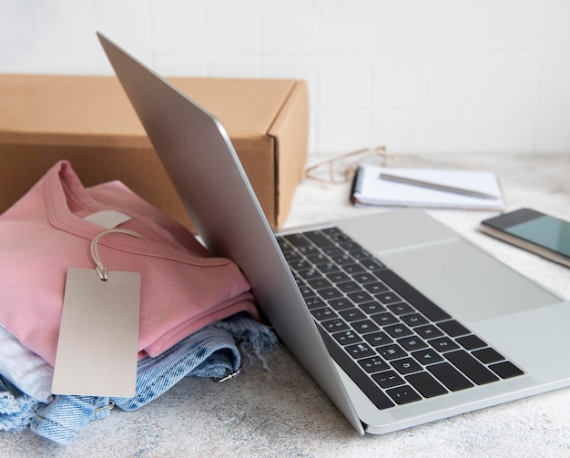 Online shopping concept a laptop and a set of womens clothing in a cardboard box