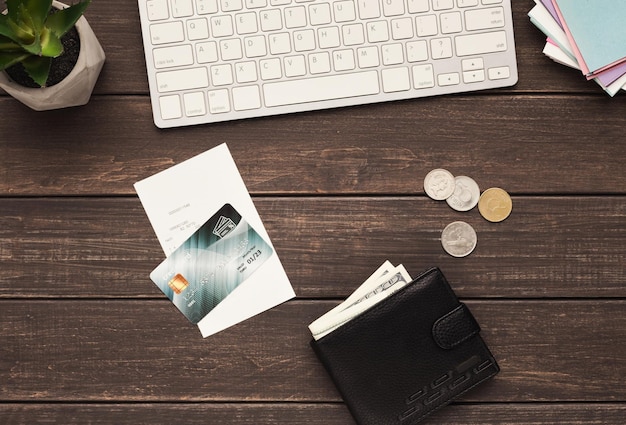 Online shopping and e-commerce. Credit card, wallet with coins and bill on wooden workplace, copy space