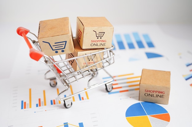 Online shopping Shopping cart box on business graph import export finance commerce