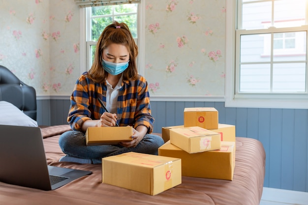 Online shopping young women start small business in a cardboard box at work.