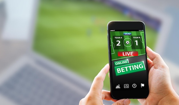 Online sports betting conceptMan hands holding mobile phone