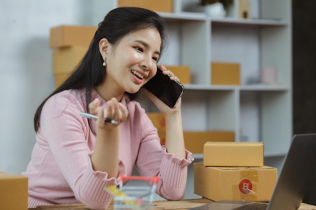 Online store salesperson is talking to customers who place order to confirm their order before packing and shipping with private shipping company Idea of opening an online store and packing products