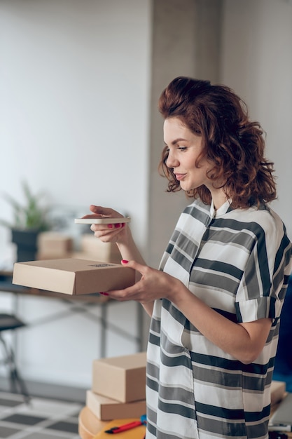 Online store worker aiming her camera at the QR code