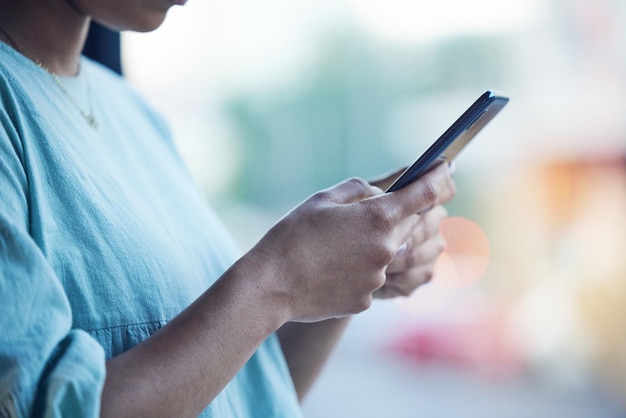 Online typing and hands of person with phone for social media browse website and text message Blurred background networking and closeup of woman on smartphone for internet research and email