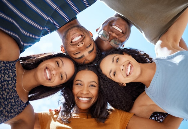 The only way to have a friend is to be one. Low angle shot of a group of young friends standing together with their heads in a huddle.