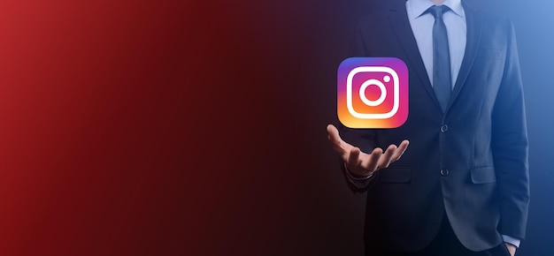 Onok,Ukraine - July 14,2021:Businessman holds, clicks, INSTAGRAM icon in his hands.Social network.global network and data customer connection.international network.