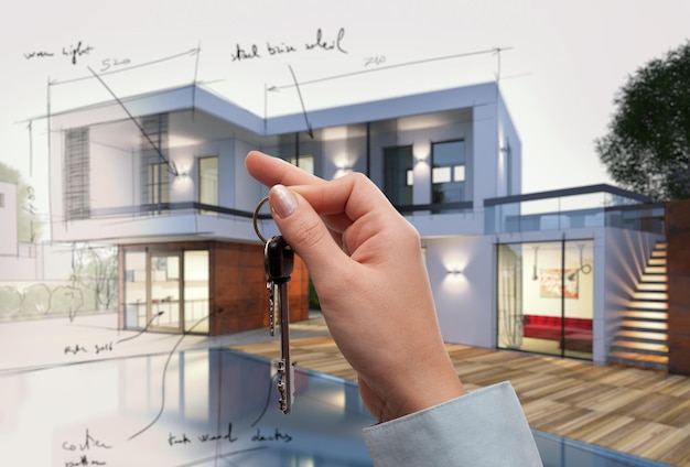 Onroerend goed verkoopconcept met sleutel van een nieuw huis in project