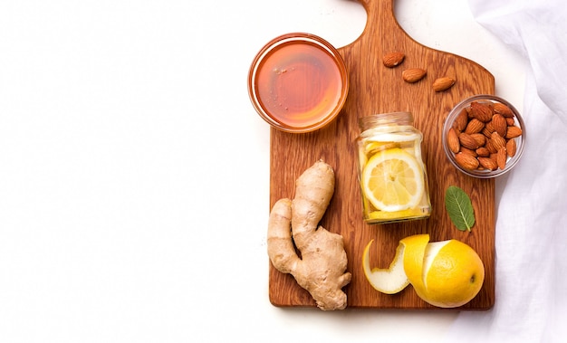 Op een houten keukenbord een citroen in honingsiroop naast de ingrediënten