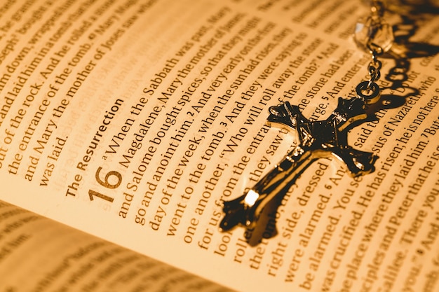open bible and silver crucifix