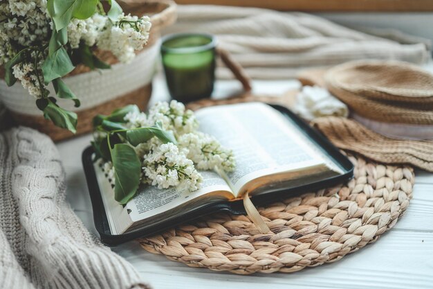 Open bible and white lilac branch christian concept