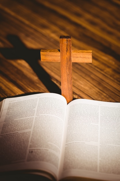 Photo open bible with crucifix icon behind