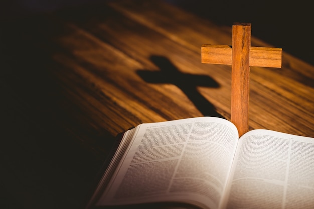 Open bible with crucifix icon behind