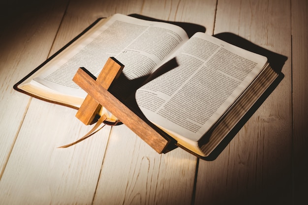 Open bible and wooden cross 