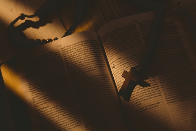 Open bible and wooden rosary beads