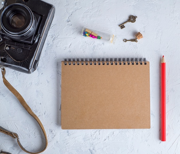 Open blank notepad on an iron spring with brown sheets 