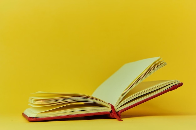 Photo open book against yellow background