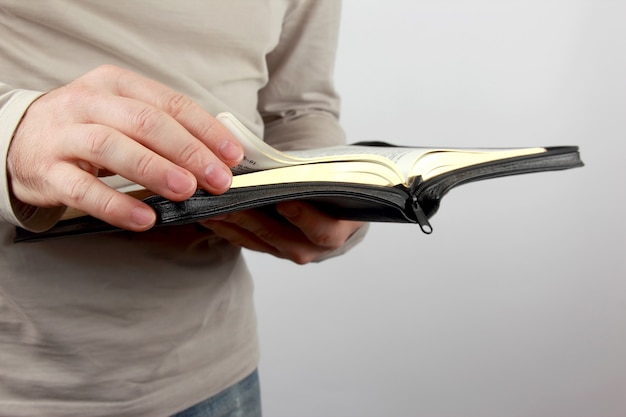 Open book the bible in the hands of men