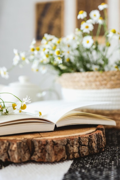 An open book and a bouquet of daisies atmospheric aesthetic photography