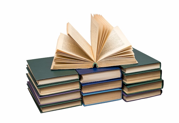 An open book lying on top of books isolated on a white background