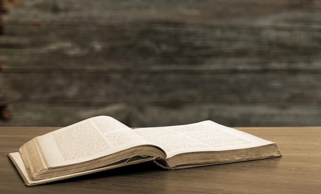 Open book on old wooden table