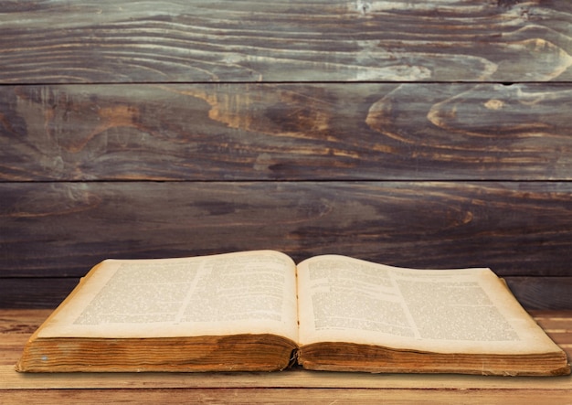 Open book on old wooden table