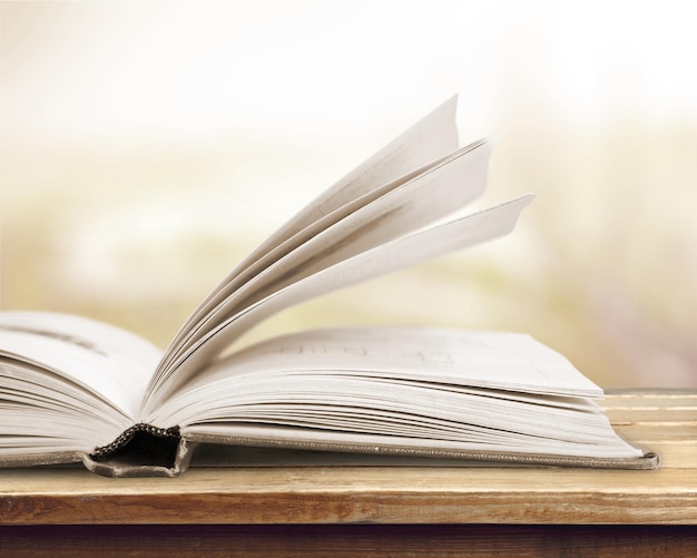 Open book on old wooden table