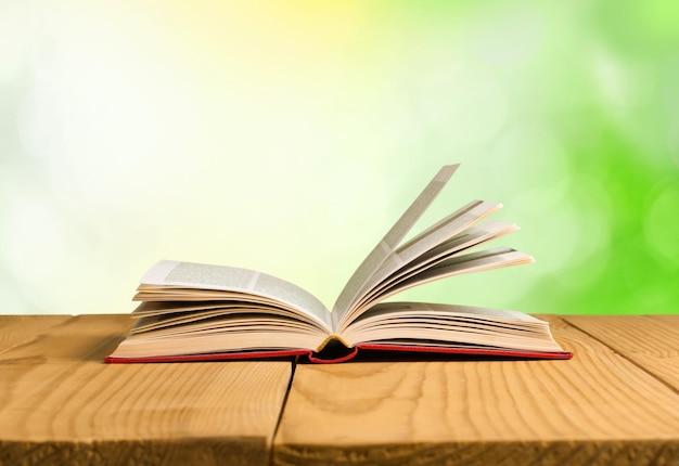 Open book on old wooden table