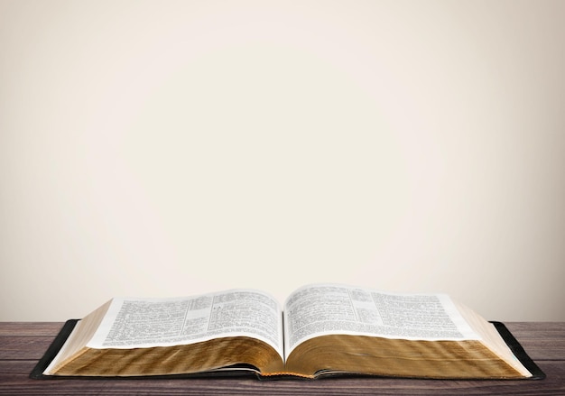 Open book on old wooden table.