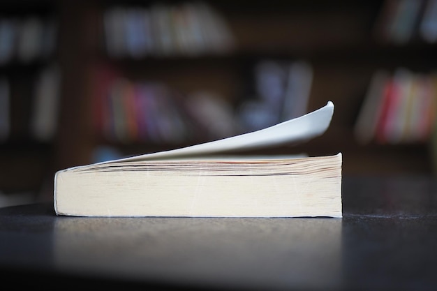 Open book and a pencil on wooden table