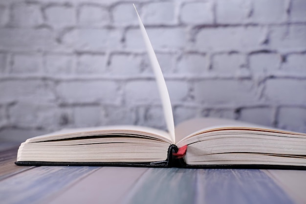 Open book and a pencil on wooden table