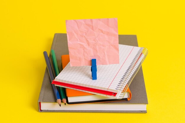 Open book on table against yellow background