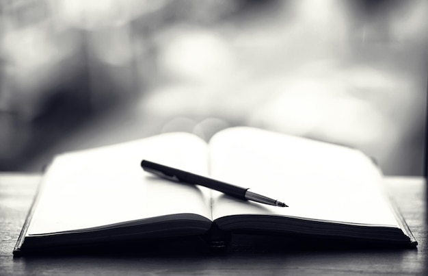 open book and a table in front of the window