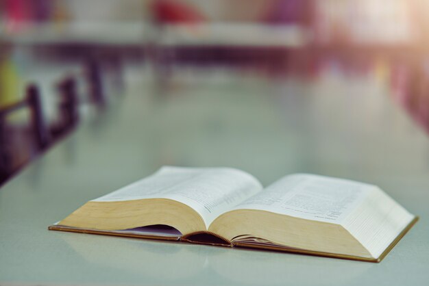 Open book on the table in library