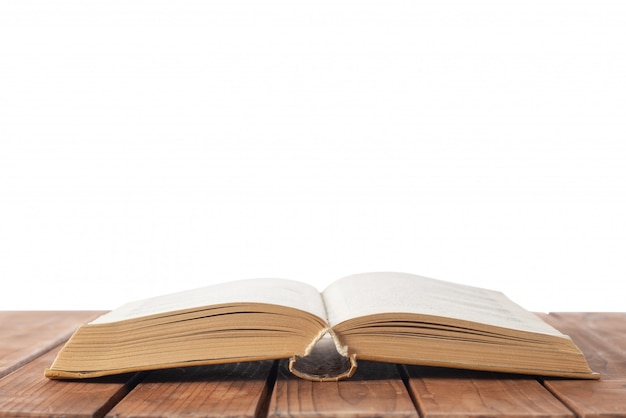 Open book on table on white isolated