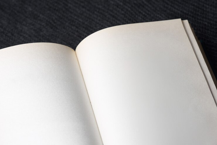 Open book with blank pages on black background