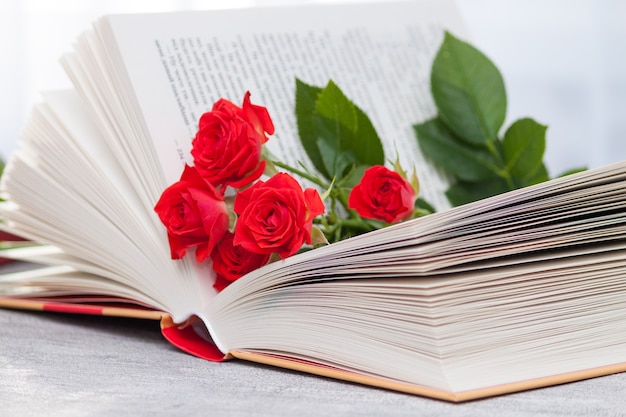 An open book with red orange roses