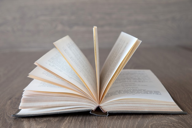 Open book on wood background