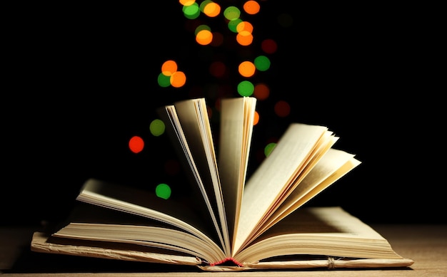 open book on wooden table on bright background