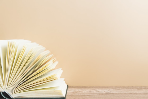 Open book on wooden table and copy space.