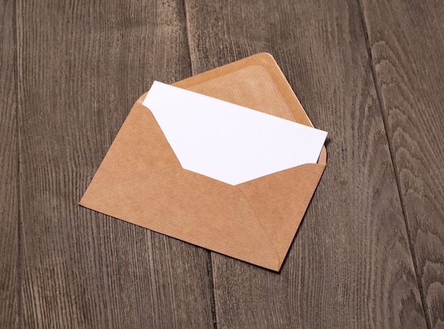 Open brown Envelope on a wooden background