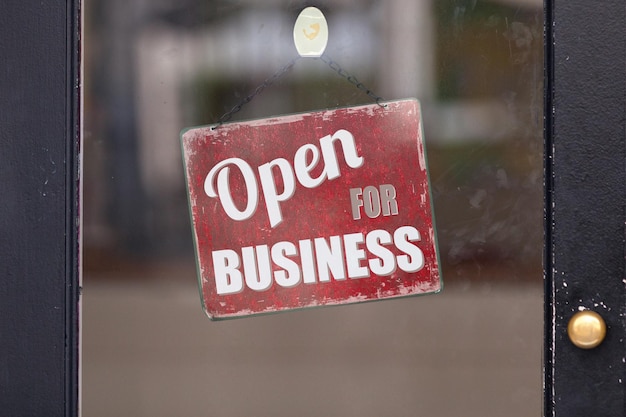 Photo open for business sign in a window